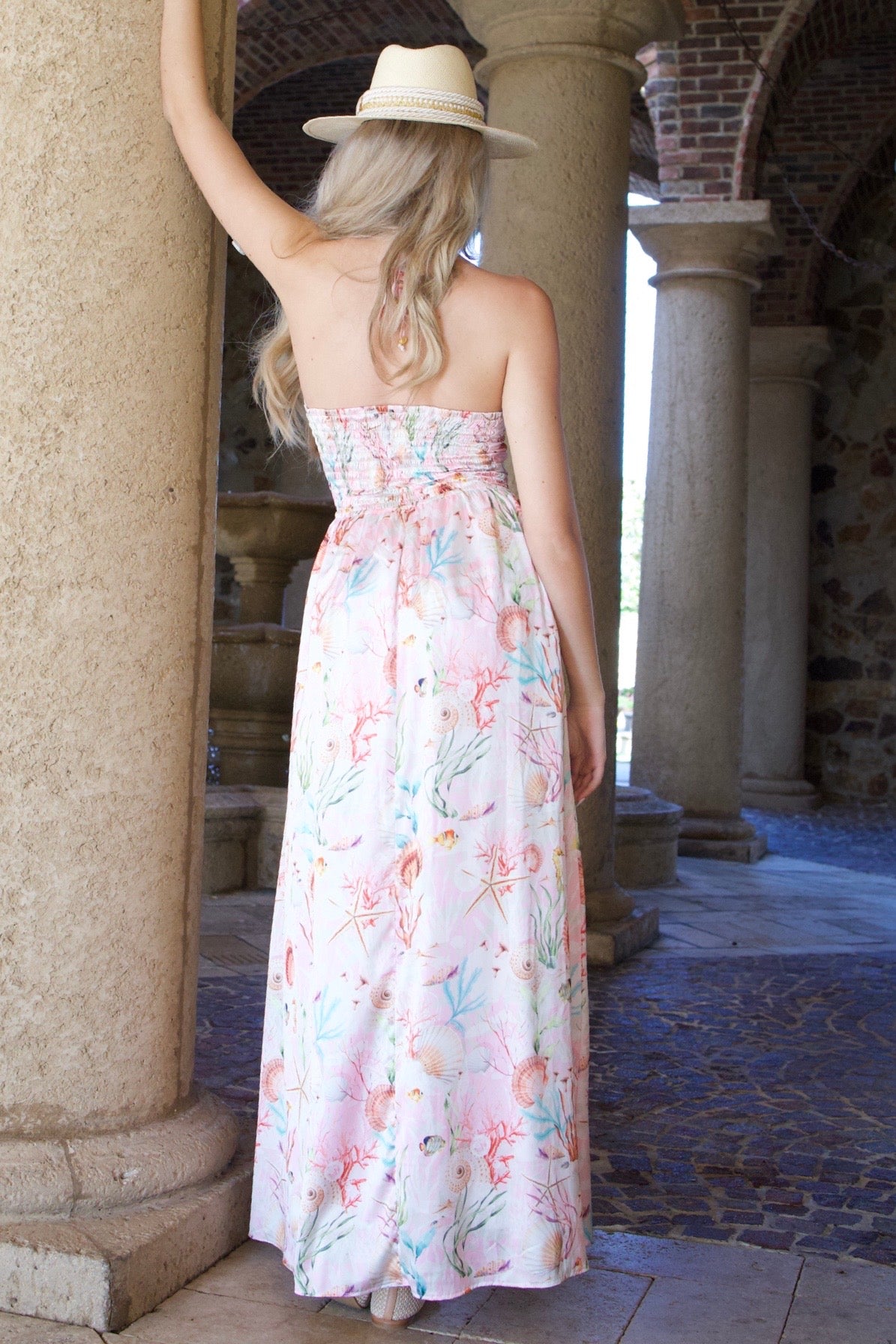 Dress with a crisscrossed front design, seashell print, silk-like polyester-spandex fabric, and elastic back for comfort.